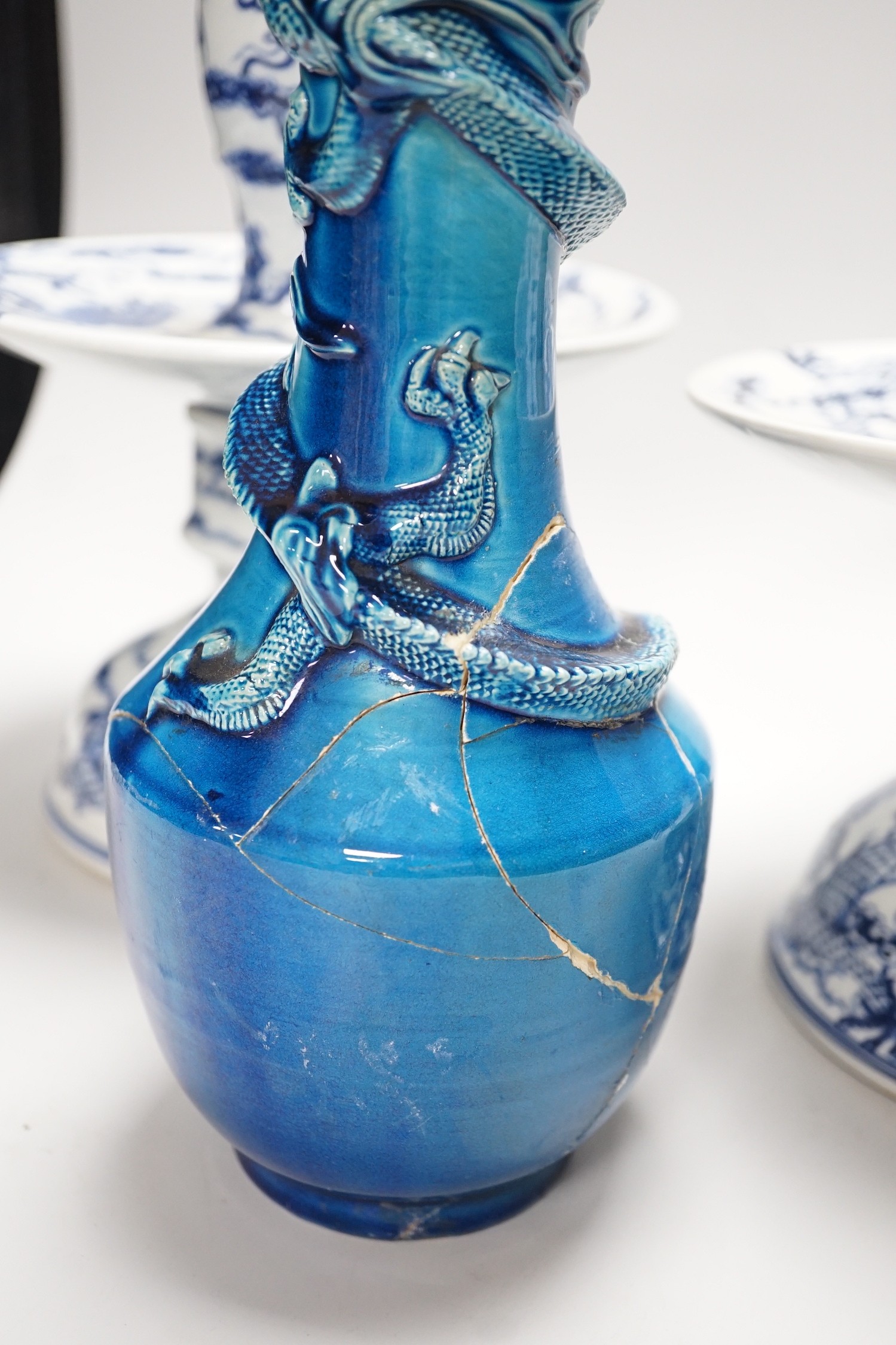 Two Chinese blue and white candlesticks and a turquoise glaze dragon vase, 30cms high